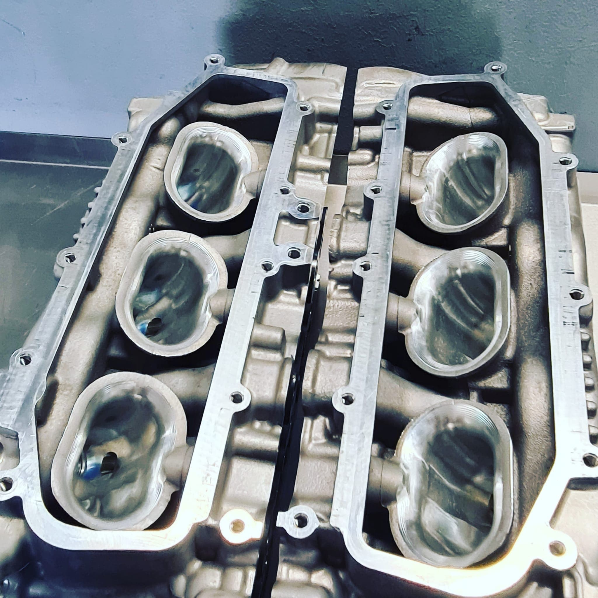 CNC-machined intake ports of a six-cylinder cylinder head, viewed from below
