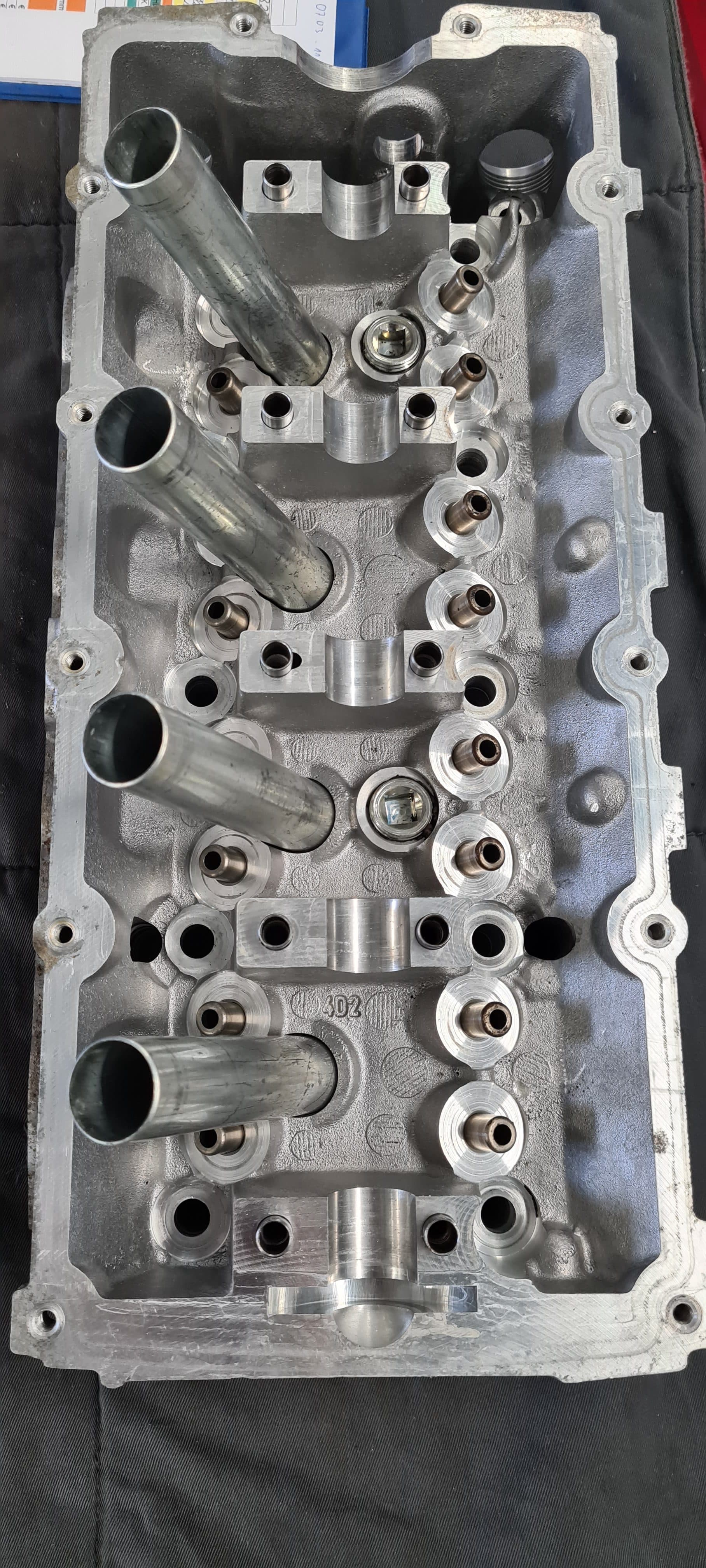 Cleaned valve cover after reconditioning, with bare polished aluminum