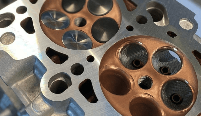 Ceramic-coated intake and exhaust ports of a cylinder head in copper tone