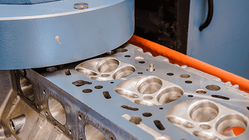 Surface-machined cylinder head with CNC-machined valve seats