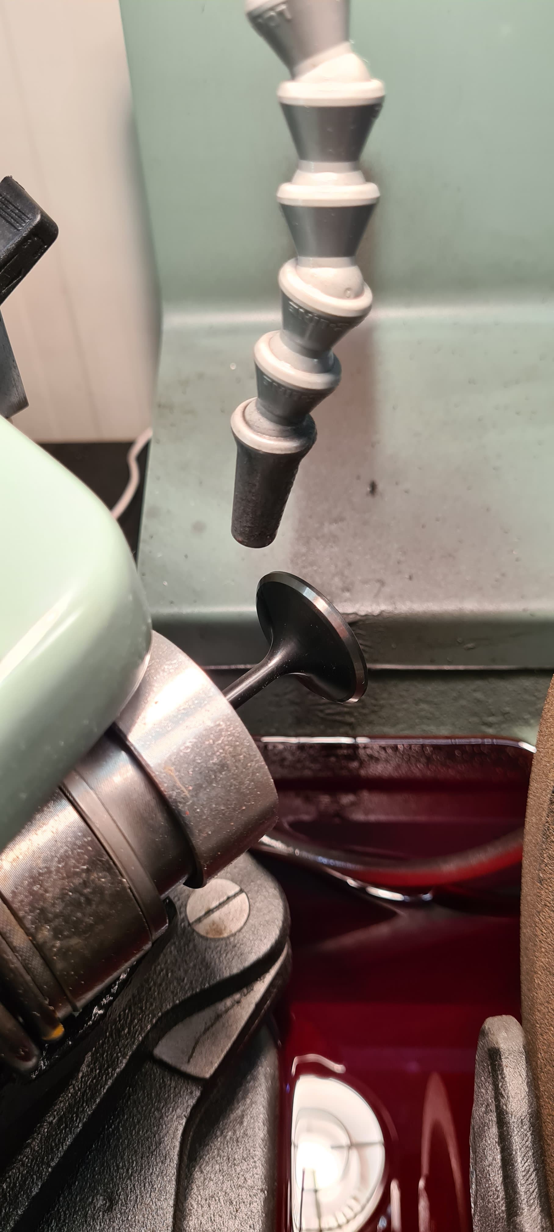 Valve grinding machine in use re-grinding an intake valve